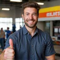 Happy customer giving a thumbs-up in auto repair shop