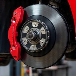 Brake service showing mechanic inspecting brake components